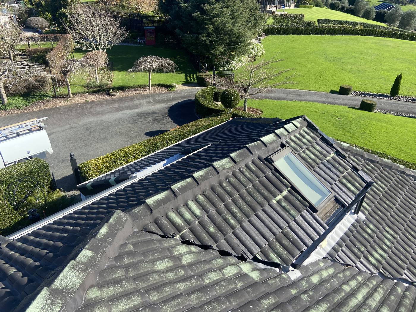 Before roof painting — moss and lichen on weathered concrete tiles