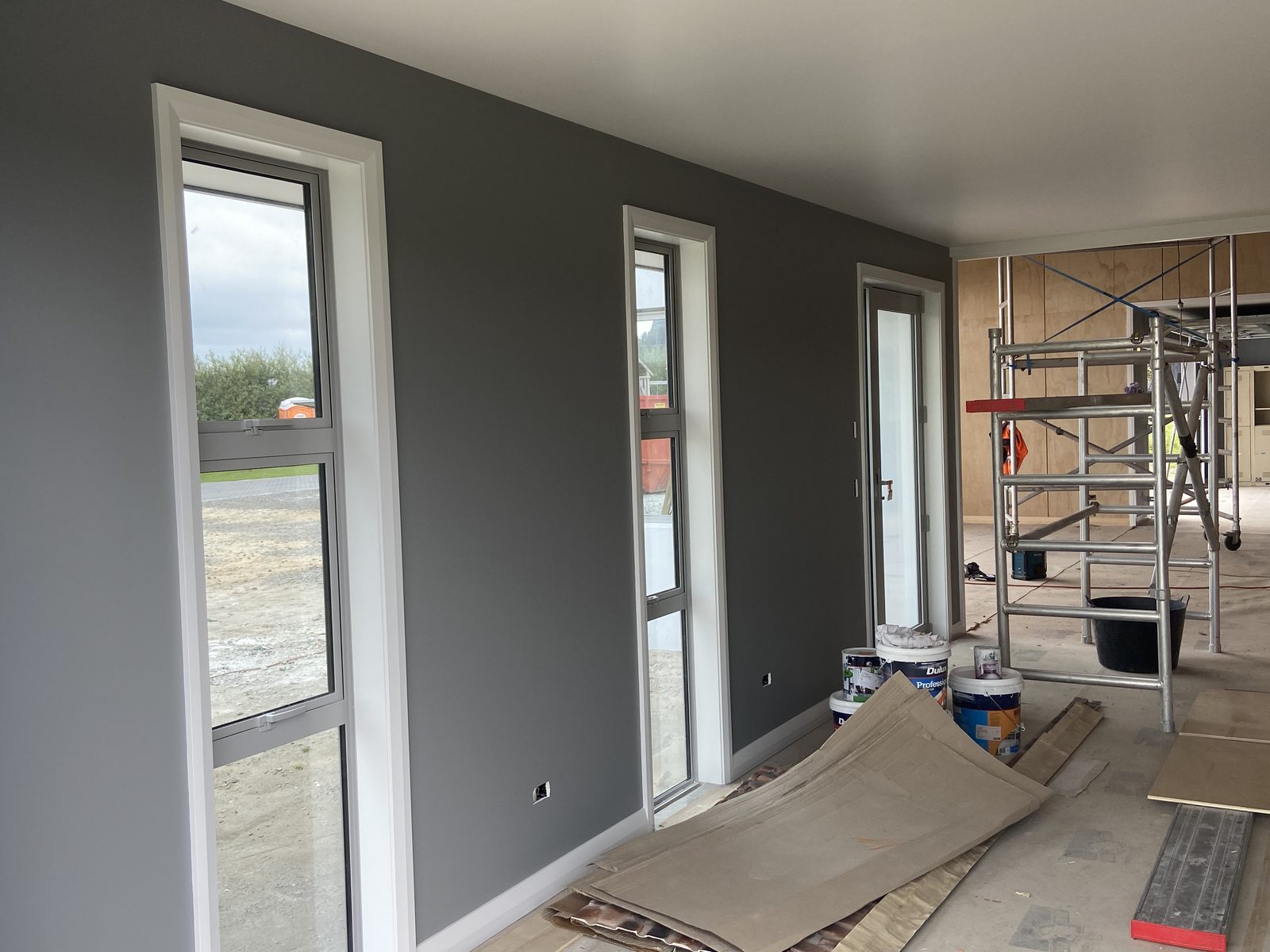Interior painting with grey walls and sharp white window trim